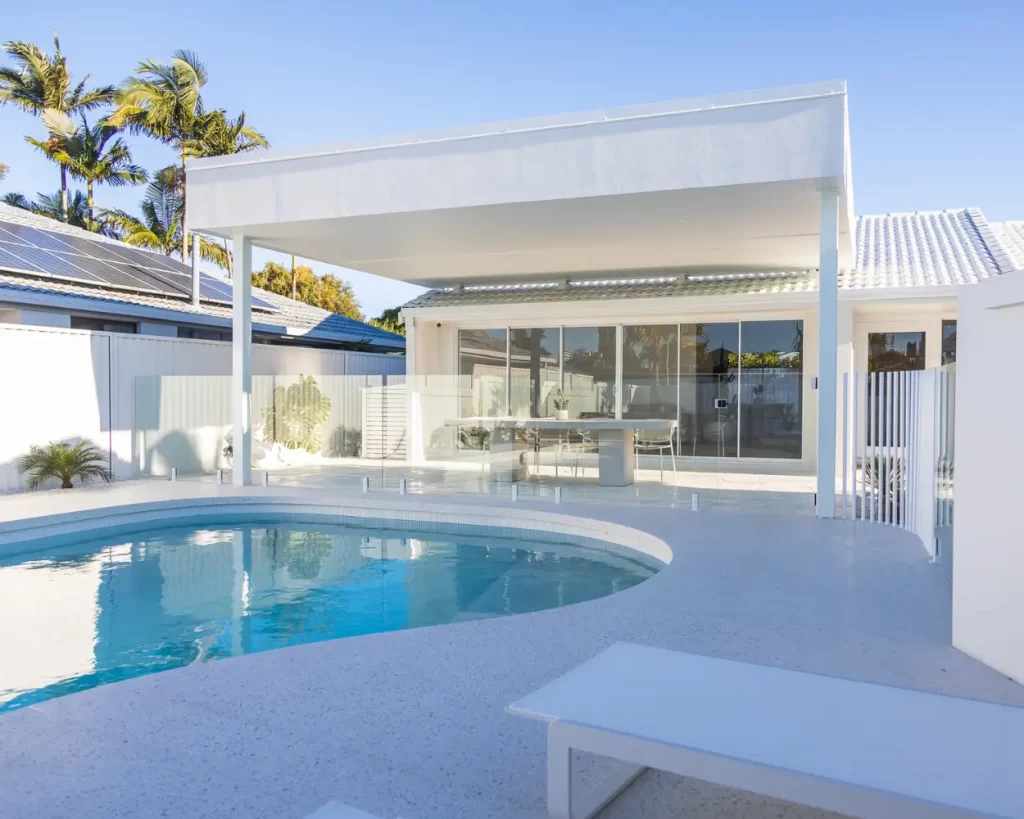 Contemporary coastal outdoor living area with covered patio and pool, designed for the Gold Coast climate by Steedbuilt