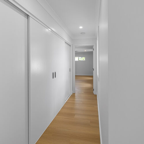 Modern hallway after renovation at 14 Sunshine Boulevard, Broadbeach Waters by Steedbuilt - engineered timber floors and built-in storage