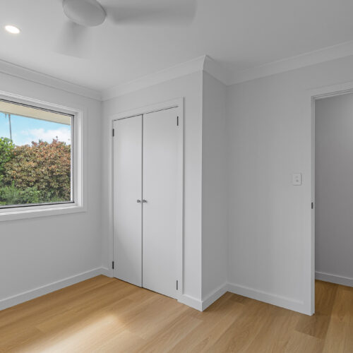 Modern bedroom after renovation at 14 Sunshine Boulevard, Broadbeach Waters - engineered timber floors and built-in wardrobe by Steedbuilt
