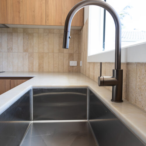Modern black kitchen tapware and undermount sink detail at 14 Sunshine Boulevard renovation by Steedbuilt