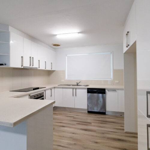 Kitchen before renovation at 14 Sunshine Boulevard, Broadbeach Waters - dated timber cabinets and layout