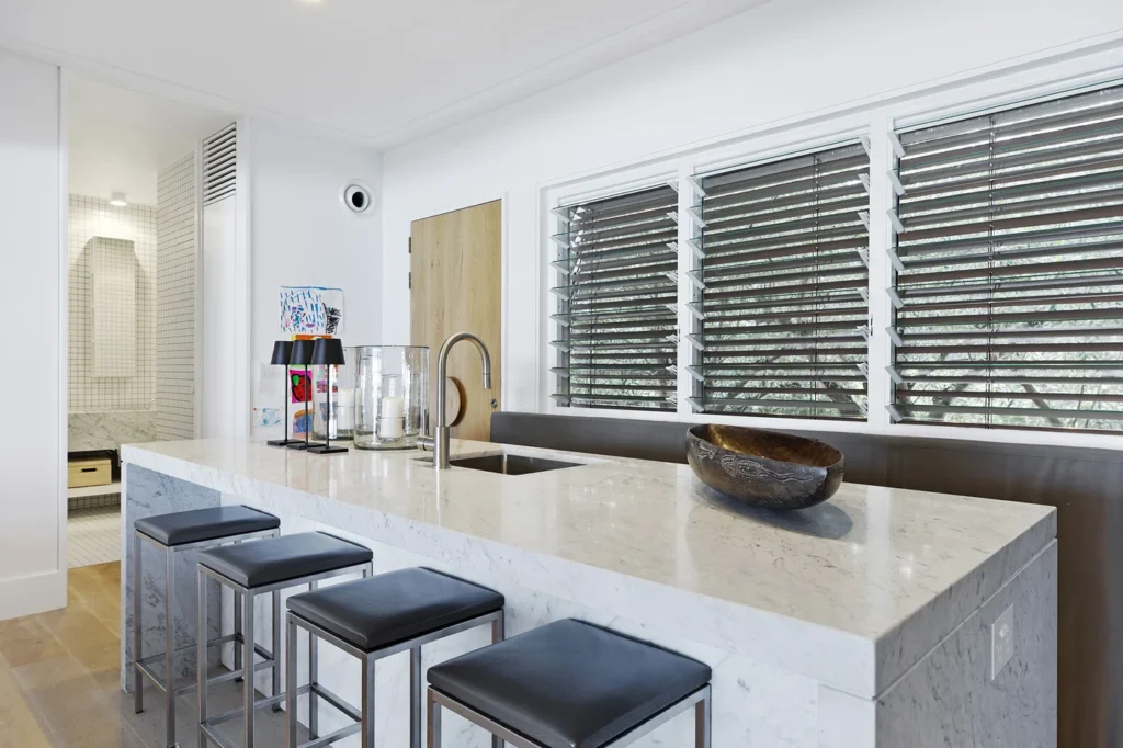 Full home renovation in Broadbeach Waters featuring a marble kitchen island by Steedbuilt